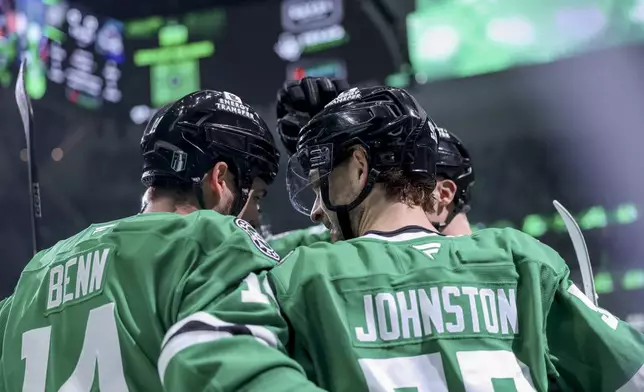 Dallas Stars left wing Jamie Benn, left, celebrates with center Wyatt Johnston, right, after Johnston scored during the first period of Game 5 of a first-round NHL hockey playoff series against the Colorado Avalanche in Dallas, Monday, April 28, 2025. (AP Photo/Gareth Patterson)