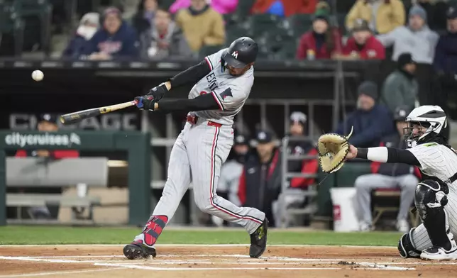 Minnesota Twins' Trevor Larnach hits a single during the first inning of a baseball game against the Chicago White Sox in Chicago, Tuesday, April 1, 2025. (AP Photo/Nam Y. Huh)