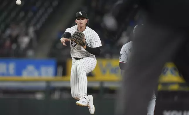 Chicago White Sox shortstop Brooks Baldwin throws out Minnesota Twins' Carlos Correa at first after forcing out Matt Wallner during the third inning of a baseball game in Chicago, Tuesday, April 1, 2025. (AP Photo/Nam Y. Huh)