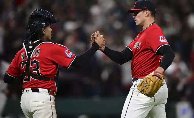 Cleveland Guardians relief pitcher Cade Smith, right, is congratulated by catcher Bo Naylor after the Guardians defeated the New York Yankees in a baseball game Tuesday, April 22, 2025, in Cleveland. (AP Photo/David Dermer)