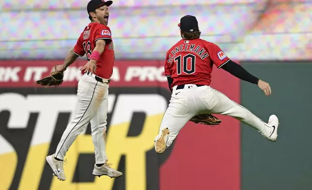 Cleveland Guardians left fielder Steven Kwan, left, and right fielder Daniel Schneemann celebrate after the Guardians defeated the New York Yankees in a baseball game Tuesday, April 22, 2025, in Cleveland. (AP Photo/David Dermer)