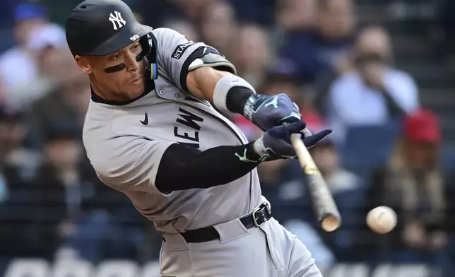 New York Yankees' Aaron Judge hits a single during the third inning of a baseball game against the Cleveland Guardians Tuesday, April 22, 2025, in Cleveland. (AP Photo/David Dermer)