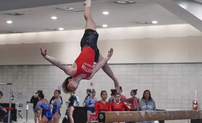 Ten Harder, of Boston University Gymnastics Club in Boston, dismounts the balance beam at the 2025 NAIGC national competition in Pittsburgh, Friday, April 4, 2025. (AP Photo/Gene J. Puskar)