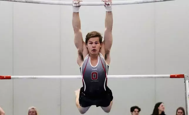 Brody Penn of Ohio State Club Gymnastics team competes on the uneven bars at the 2025 NAIGC national competition in Pittsburgh, Friday, April 4, 2025. (AP Photo/Gene J. Puskar)