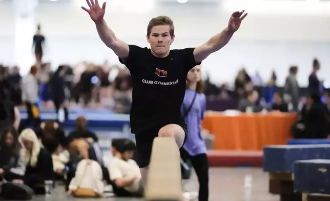 Brody Penn of Ohio State Club Gymnastics team warms up on the balance beam at the 2025 NAIGC national competition in Pittsburgh, Friday, April 4, 2025. (AP Photo/Gene J. Puskar)