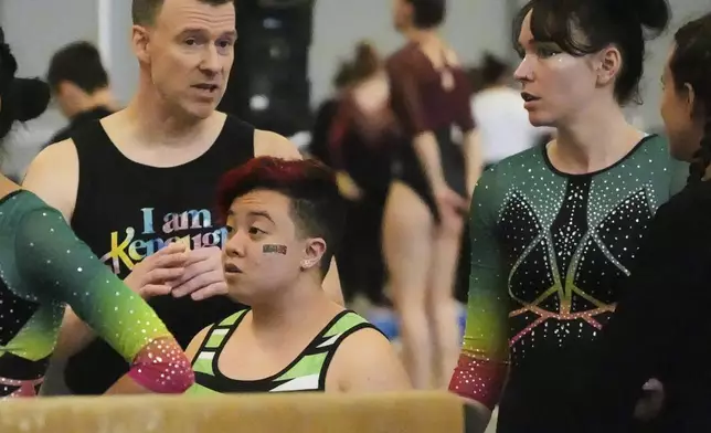 Raiden Hung, center, of Jurassic Gymnastics from Boston, to compete on the balance beam with teammates Eric Petersen, left, and Fay Malay at the 2025 NAIGC national competition in Pittsburgh, Friday, April 4, 2025. (AP Photo/Gene J. Puskar)