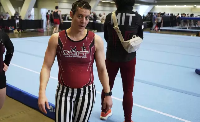 Julia Sharpe, left, of the MIT Gymnastic Club of Boston, finishes her warm up before competing in the floor exercise at the 2025 NAIGC national competition in Pittsburgh, Friday, April 4, 2025. (AP Photo/Gene J. Puskar)