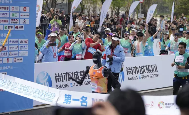 Sky Project Ultra robot crosses the finish line to win the world's first robot half marathon during the Humanoid Robot Half-Marathon held in Beijing on Saturday, April 19, 2025. (AP Photo/Ng Han Guan)