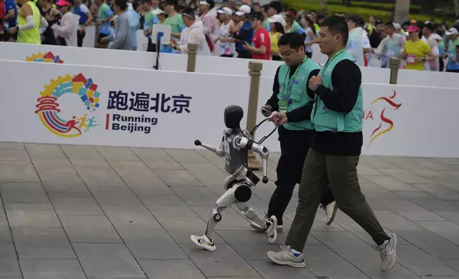 A robot takes part in what is billed as the world's first robot half marathon during the Humanoid Robot Half-Marathon held in Beijing on Saturday, April 19, 2025. (AP Photo/Ng Han Guan)