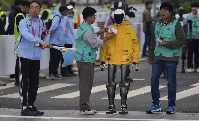 A robot takes part in what is billed as the world's first robot half marathon during the Humanoid Robot Half-Marathon held in Beijing on Saturday, April 19, 2025. (AP Photo/Ng Han Guan)
