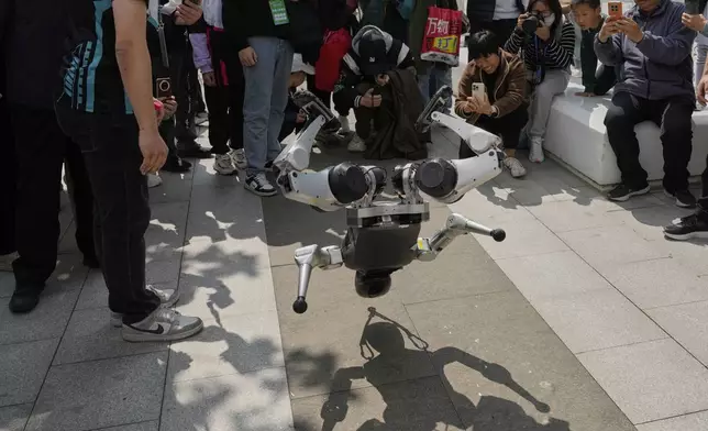A robot demonstrates a backflip after the Humanoid Robot Half-Marathon held in Beijing on Saturday, April 19, 2025. (AP Photo/Ng Han Guan)