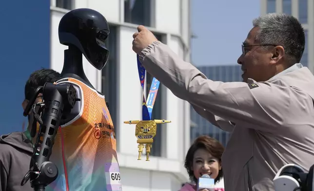 The Sky Project Ultra robot also known as Tien Kung Ultra is awarded the gold medal after winning the Humanoid Robot Half-Marathon held in Beijing on Saturday, April 19, 2025. (AP Photo/Ng Han Guan)