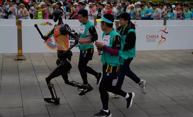 A robot takes part in what is billed as the world's first robot half marathon during the Humanoid Robot Half-Marathon held in Beijing on Saturday, April 19, 2025. (AP Photo/Ng Han Guan)