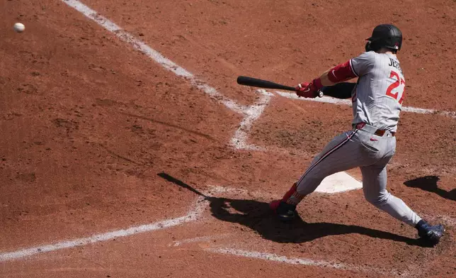 Minnesota Twins' Ryan Jeffers hits an RBI single during the sixth inning of a baseball game against the Kansas City Royals, Thursday, April 10, 2025, in Kansas City, Mo. (AP Photo/Charlie Riedel)