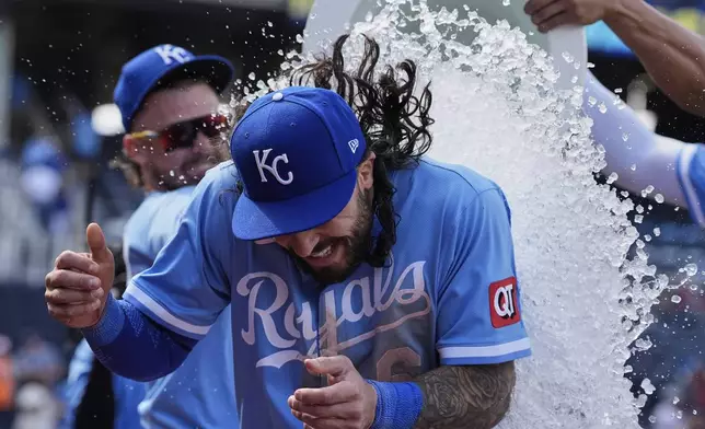 Kansas City Royals' Jonathan India is doused by teammates after their baseball game against the Minnesota Twins, Thursday, April 10, 2025, in Kansas City, Mo. (AP Photo/Charlie Riedel)