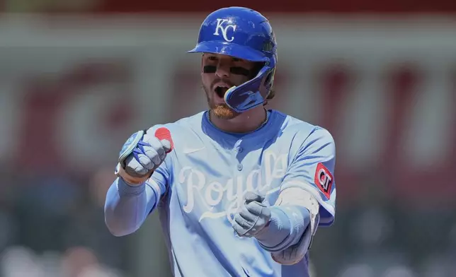 Kansas City Royals' Bobby Witt Jr. celebrates on second after hitting a double during the third inning of a baseball game against the Minnesota Twins, Thursday, April 10, 2025, in Kansas City, Mo. (AP Photo/Charlie Riedel)