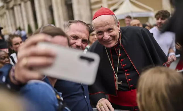 Cardinal Christoph Schönborn poses for selfie photos with people outside St. Mary Major Basilica in Rome, Sunday, April 27, 2025. (AP Photo/Bernat Armangue)