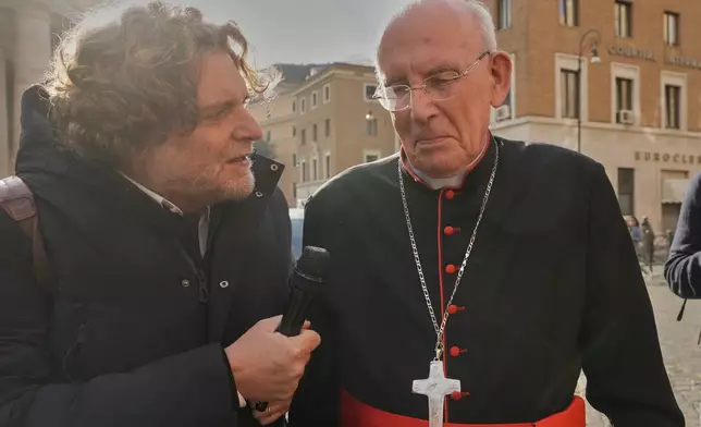 Cardinal Sean Brady is approached by reporters as he arrives for a college of cardinals' meeting, at the Vatican, Monday, April 28, 2025. (AP Photo/Gregorio Borgia)