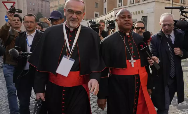 Cardinal Pierbattista Pizzaballa, left, and Cardinal Fridolin Ambongo Besungu arrive for a college of cardinals' meeting, at the Vatican, Monday, April 28, 2025. (AP Photo/Gregorio Borgia)