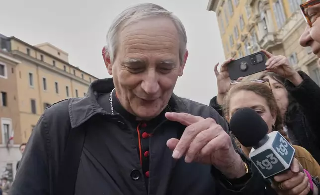 Cardinal Matteo Zuppi is approached by reporters as he arrives for a college of cardinals' meeting, at the Vatican, Monday, April 28, 2025. (AP Photo/Gregorio Borgia)