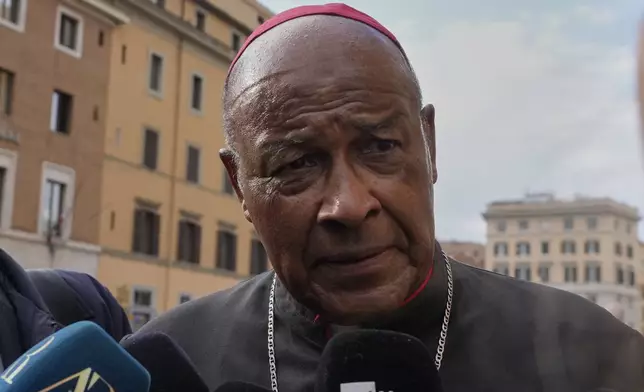 Cardinal Wilfrid Napier is approached by reporters as he arrives for a college of cardinals' meeting, at the Vatican, Monday, April 28, 2025. (AP Photo/Gregorio Borgia)