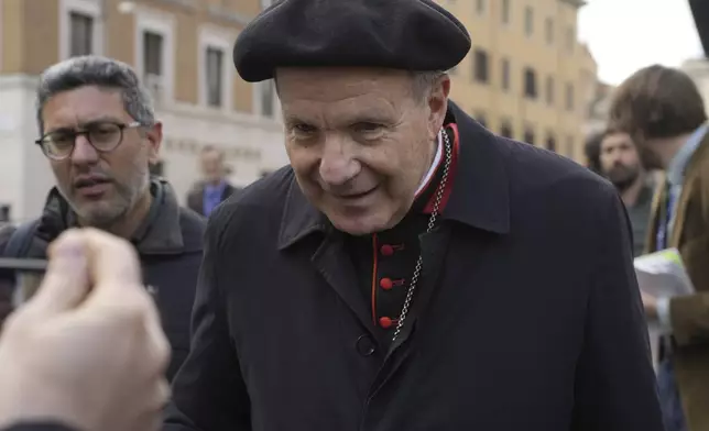 Cardinal Christoph Schönborn is approached by reporters as he arrives for a college of cardinals' meeting, at the Vatican, Monday, April 28, 2025. (AP Photo/Gregorio Borgia)