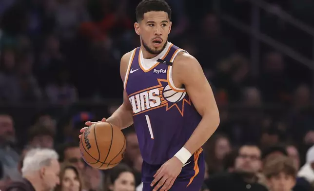Phoenix Suns' Devin Booker dribbles during the first half of an NBA basketball game against the New York Knicks, Sunday, April 6, 2025, in New York. (AP Photo/Pamela Smith)