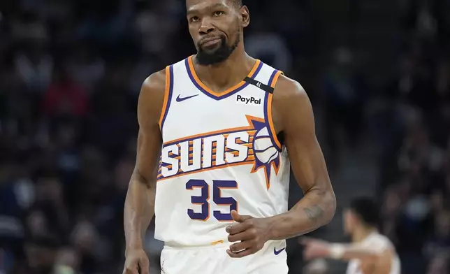 Phoenix Suns forward Kevin Durant jogs down the court during the second half of an NBA basketball game against the Minnesota Timberwolves, Friday, March 28, 2025, in Minneapolis. (AP Photo/Abbie Parr)
