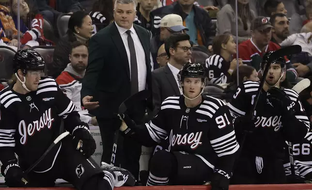 New Jersey Devils head coach Sheldon Keefe directs his team in the third period of an NHL hockey game against the New York Islanders Sunday, April 13, 2025, in Newark, N.J. (AP Photo/Adam Hunger)