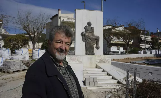 Simos Daniilidis, mayor of Neapoli-Sykies, poses in front of a monument in Thessaloniki, Greece, Friday, April 11, 2025. (AP Photo/Thanassis Stavrakis)