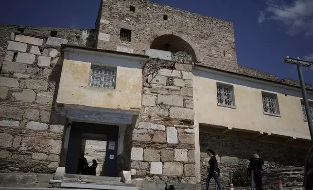 People walk outside Yedi Kule prison, which is now a museum, in the city of Thessaloniki, Greece, Saturday, April 12, 2025. (AP Photo/Thanassis Stavrakis)
