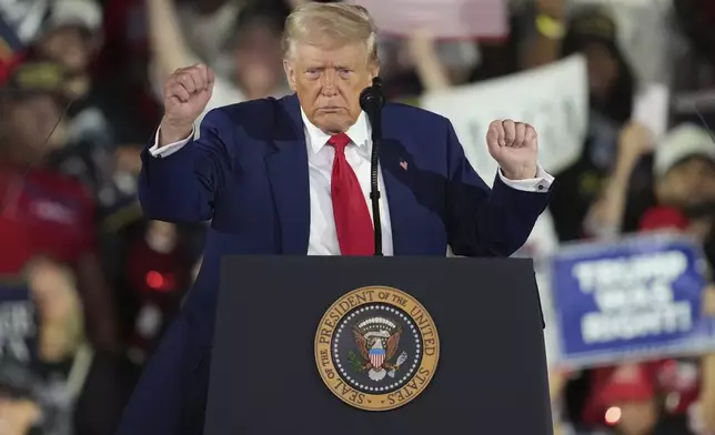 President Donald Trump dances after speaking at Macomb Community College, Tuesday, April 29, 2025, in Warren Mich. (AP Photo/Paul Sancya)