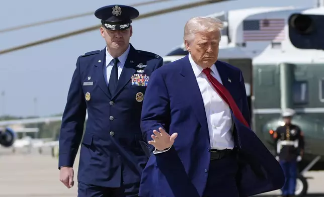 President Donald Trump, right, walks with Col. Kevin Eley, 89th Operations Group commander, before boarding Air Force One, Tuesday, April 29, 2025, at Joint Base Andrews, Md. (AP Photo/Alex Brandon)