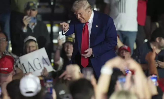 President Donald Trump gestures after speaking at Macomb Community College, Tuesday, April 29, 2025, in Warren Mich. (AP Photo/Paul Sancya)