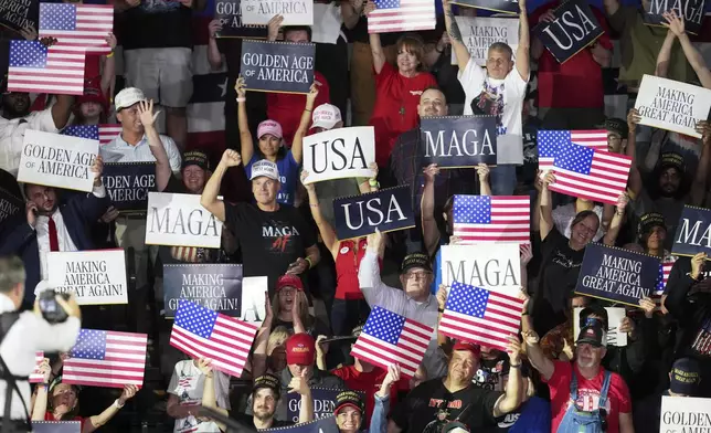 People arrive before President Donald Trump speaks on his first 100 days at Macomb County Community College Sports Expo Center, Tuesday, April 29, 2025, in Warren, Mich. (AP Photo/Paul Sancya)