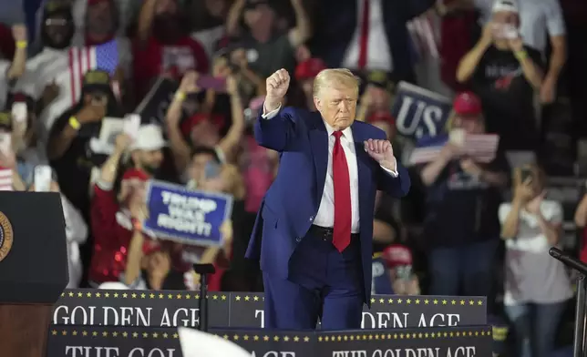 President Donald Trump dances after speaking on his first 100 days at Macomb County Community College Sports Expo Center, Tuesday, April 29, 2025, in Warren, Mich. (AP Photo/Paul Sancya)