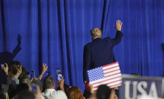 President Donald Trump waves as he departs after speaking at Macomb Community College, Tuesday, April 29, 2025, in Warren Mich. (AP Photo/Paul Sancya)