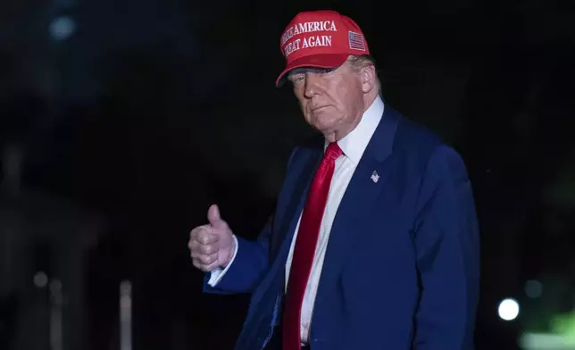 President Donald Trump gestures to reporters as he walks on the South Lawn of the White House in Washington, Tuesday, April 29, 2025. (AP Photo/Jose Luis Magana)