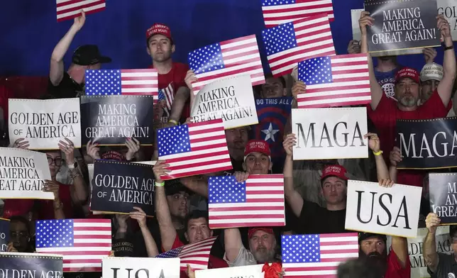 People arrive before President Donald Trump speaks on his first 100 days at Macomb County Community College Sports Expo Center, Tuesday, April 29, 2025, in Warren, Mich. (AP Photo/Paul Sancya)