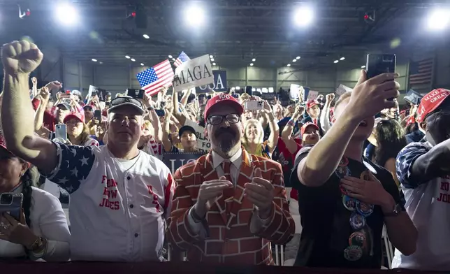 Supporters cheer as President Donald Trump arrives to speak on his first 100 days at Macomb County Community College Sports Expo Center, Tuesday, April 29, 2025, in Warren, Mich. (AP Photo/Alex Brandon)