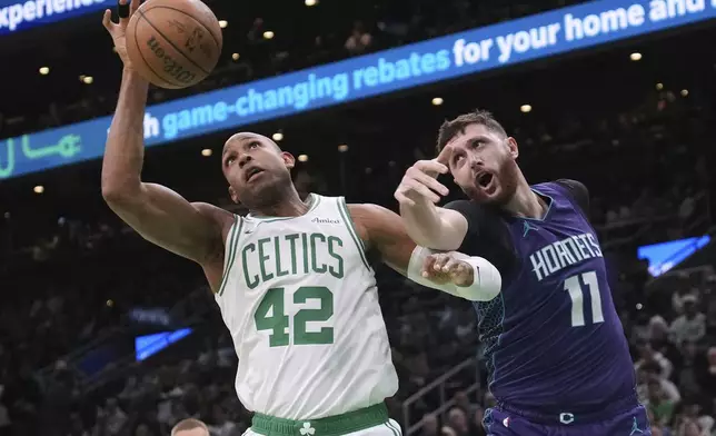 Boston Celtics center Al Horford (42) battles for a rebound against Charlotte Hornets center Jusuf Nurkic (11) during the first half of an NBA basketball game, Friday, April 11, 2025, in Boston. (AP Photo/Charles Krupa)