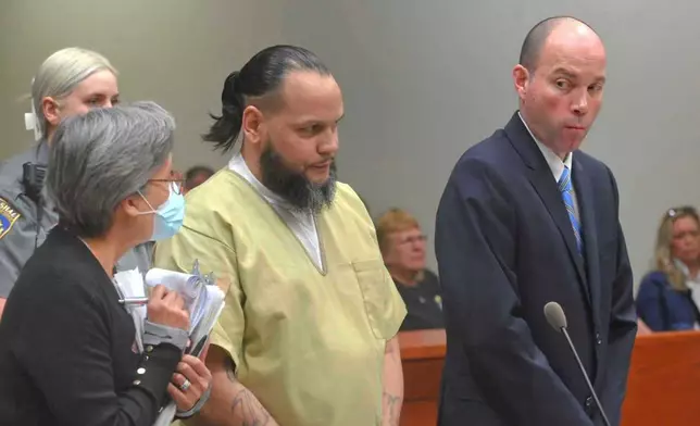 Alex Oyola-Sanchez, center, with his public defender Chris Eddy, right, and a Spanish interpreter during Oyola-Sanchez's sentencing at state Superior Court in New Britain, Conn., April 29, 2025. (Jim Michaud/Hearst Connecticut Media via AP)
