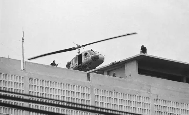FILE- A U.S. Marine helicopter takes off from helipad on top of the American Embassy in Saigon, Vietnam, April 30, 1975. (AP Photo/Phu)