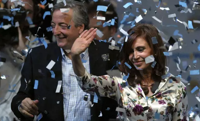 FILE - Argentine presidential candidate Cristina Fernandez de Kirchner, right, and Argentina's President Nestor Kirchner wave to supporters at their headquarters in Buenos Aires, Argentina, Oct. 28, 2007. (AP Photo/Daniel Luna, File)