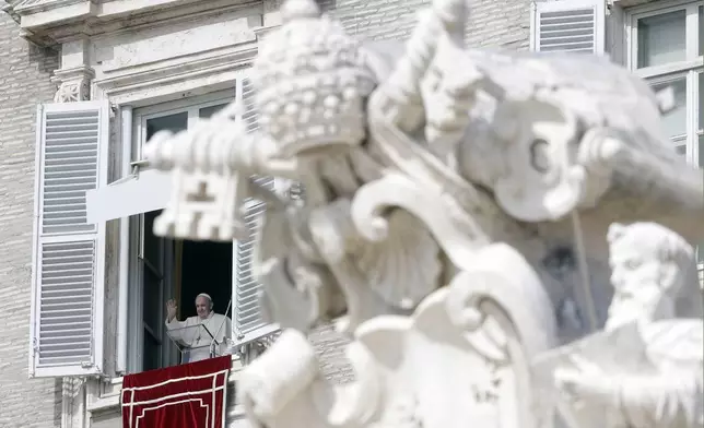 FILE - Pope Francis waves during the Angelus noon prayer delivered from his studio window overlooking St. Peter's Square, at the Vatican, Oct. 4, 2020. (AP Photo/Gregorio Borgia, File)