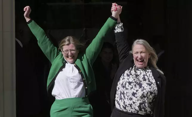 Marion Calder, right, and Susan Smith, left, from For Women Scotland, celebrate outside after the U.K. Supreme Court ruled that a woman is someone born biologically female, excluding transgender people from the legal definition in a long-running dispute between the feminist group and the Scottish government, in London Wednesday, April 16, 2025. (AP Photo/Kin Cheung)