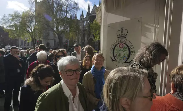 Activists queue to enter the Supreme Court to challenge gender recognition laws, in London, Wednesday, April 16, 2025. (AP Photo/Kin Cheung)