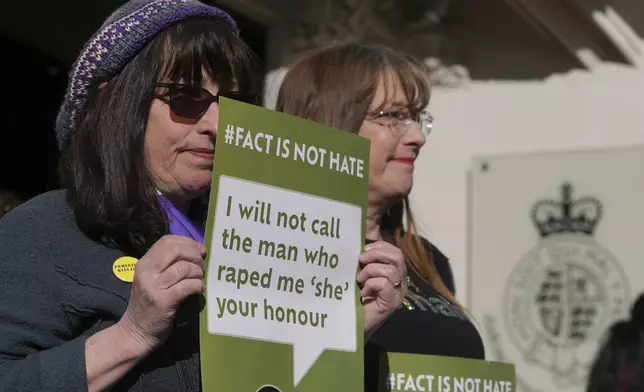 Women's rights activists hold placards outside the Supreme Court to challenge gender recognition laws, in London, Wednesday, April 16, 2025. (AP Photo/Kin Cheung)