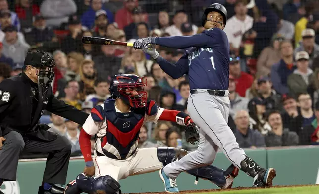 Seattle Mariners designated hitter Jorge Polanco takes a swinging strike during the sixth inning of a baseball game against the Boston Red Sox, Tuesday, April 22, 2025, in Boston. (AP Photo/Mark Stockwell)