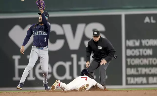 A throw to Seattle Mariners shortstop J.P. Crawford, left, comes up short allowing Boston Red Sox's Ceddanne Rafaela, right, to slide safe into second base during the fifth inning of a baseball game, Tuesday, April 22, 2025, in Boston. (AP Photo/Mark Stockwell)